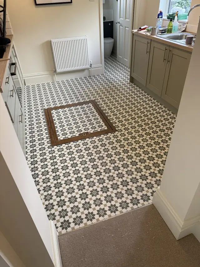 Black and white patterned vinyl floor in a utility room